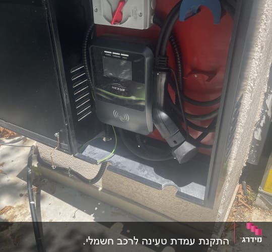 תחנת טעינה חשמלית עם כבלים ומתג אדום
